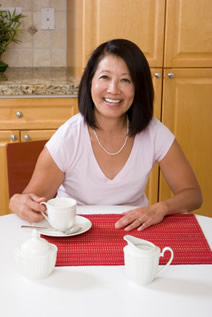 lady at kitchen table with coffee
